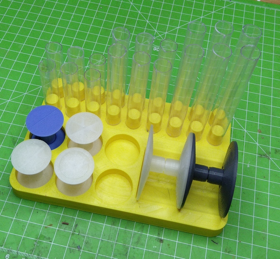 a holder holding 6 complete medium bases, two large ones, and 18 pieces of tube in three lengths