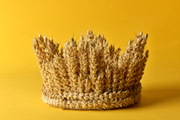 crown made of wheat ears of cereals on a yellow background